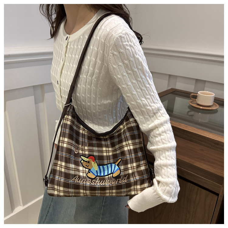 A new 2024 trendy and stylish backpack for women, featuring a cartoon checkered single-shoulder crossbody bag and a tote bag undefined