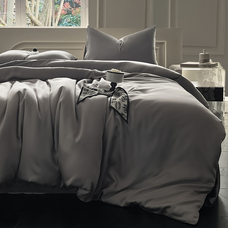 Juego de cama de verano de cuatro piezas de seda de hielo de lujo ligero 2025 nueva funda de edredón sábana sábana sábana ropa de cama desnuda sedosa