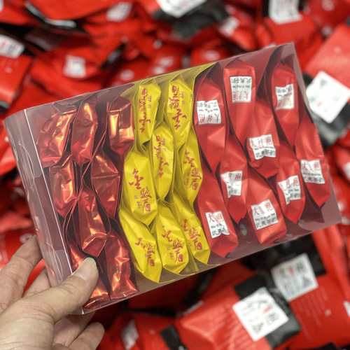 Tieguanyin tea, Anxi Da Hong Pao, Jin Jun Mei, and Xiao Zhong in a PC box, packaged as a viral high mountain black tea, shipped individually.