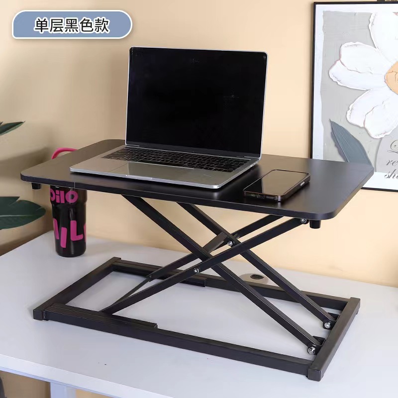 気動机の上のコンピュータの机は立式の事務室の台の上に立って高くなるノートの折り畳みの机で机を昇降することができます。