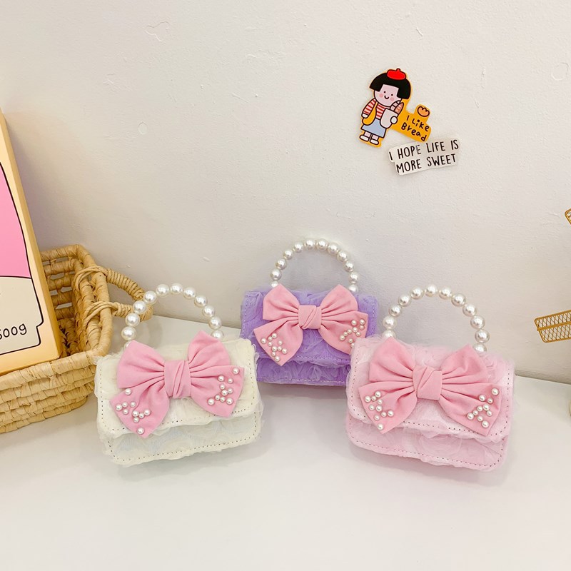 Dulce princesa bolso de hombro de perlas de aire extranjero bolso de mano para niños 2025 mini bolso de arco para niños