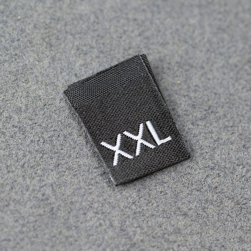 En stock Etiqueta de tamaño de alta densidad en blanco y negro Etiqueta de tamaño universal Etiqueta de código de letra inglesa Pantalones Etiqueta de código de cuello de camiseta