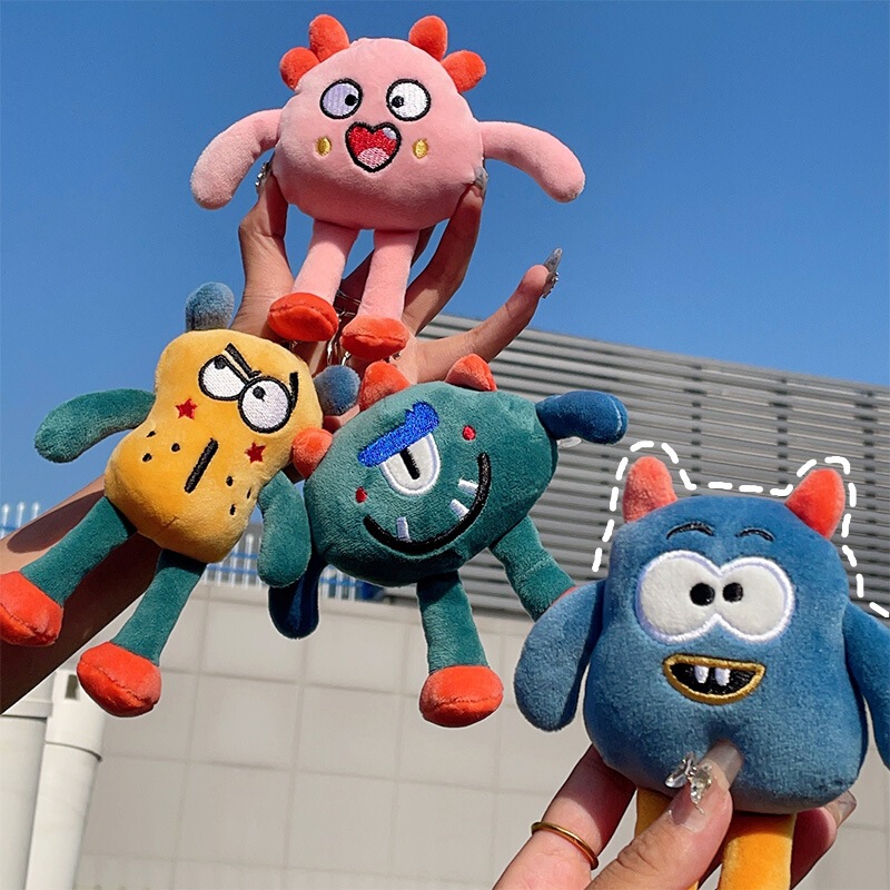 アニメのかわいいおかしな目の小さい怪獣のぬいぐるみのペンダントの学生のぬいぐるみのバッグのキーホルダーの飾り|undefined