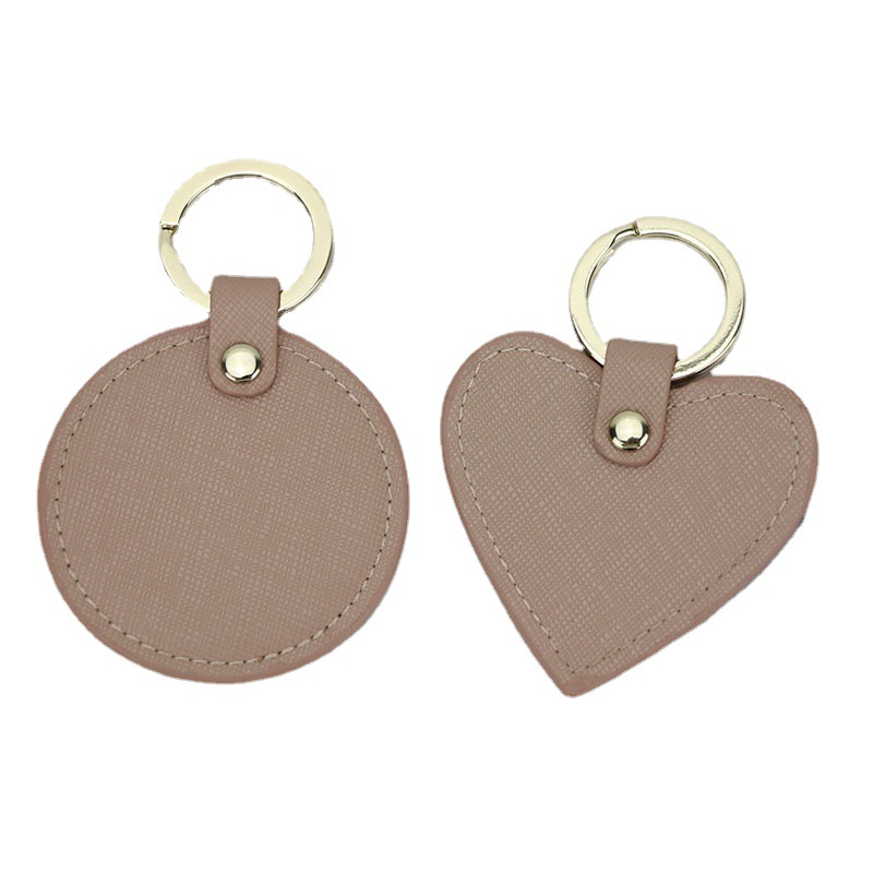Llavero redondo de cuero genuino personalizado creativo simple colgante hombres y mujeres pequeño exquisito pequeño regalo al por mayor todo a juego