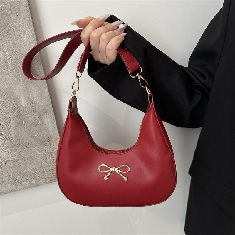 Sensación de la axila bolso pequeño mujer 2025 primavera nueva moda todo-fósforo bolso de hombro diseño de nicho bolso de palo francés mujer