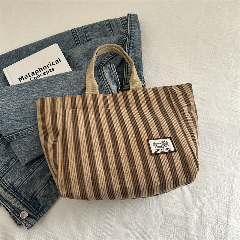 Bolso tote de tela a rayas de estilo europeo y americano, nuevo bolso pequeño de moda, bolso femenino portátil, bolso de almuerzo de mano, bolso de bocadillos