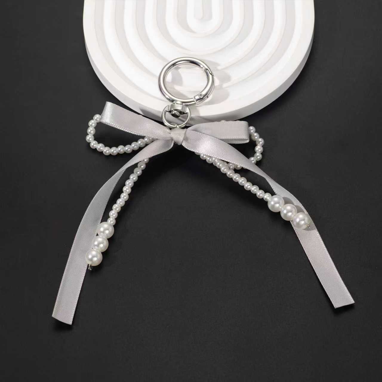 Coreano estricto color curry cinta arco perla bolsos bolsos llavero de encaje dulce bolsos colgantes pequeños vientos fragrantes