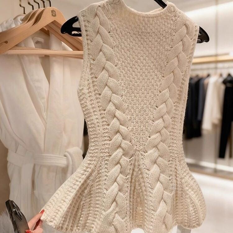 Stylish and unique knitted sleeveless top with a twisted design, perfect for spring, featuring a French-inspired, subtly alluring style and a fitted silhouette. New arrival