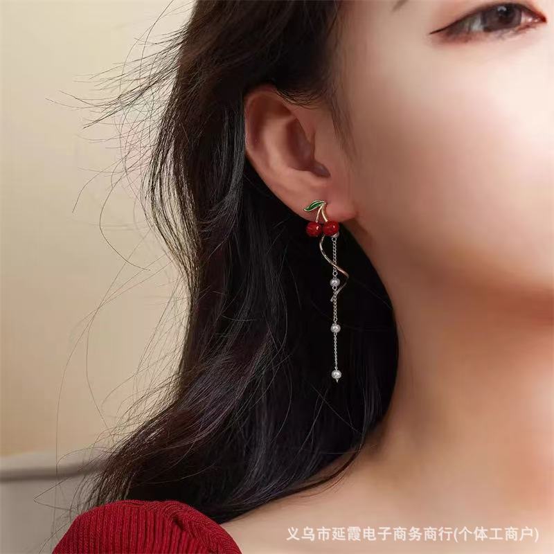 Demi-season red asymmetrical small design earrings with tassels