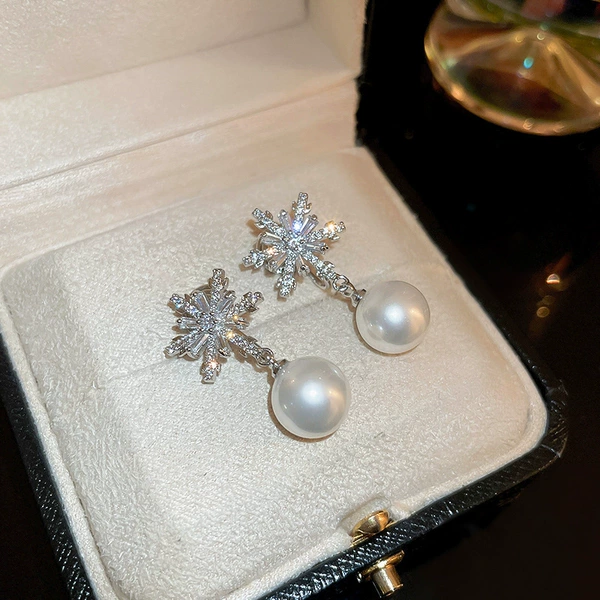 Silver white silver needle from pearl, with snowflakes