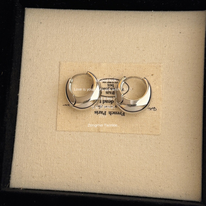 A pair of silver earrings [copper and platinum]