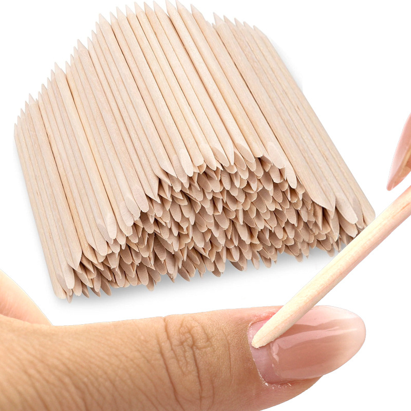 Herramientas de manicura al por mayor palo de madera de naranja palo de madera empuja la piel muerta 100 palos de madera de naranja de doble punta en bolsas