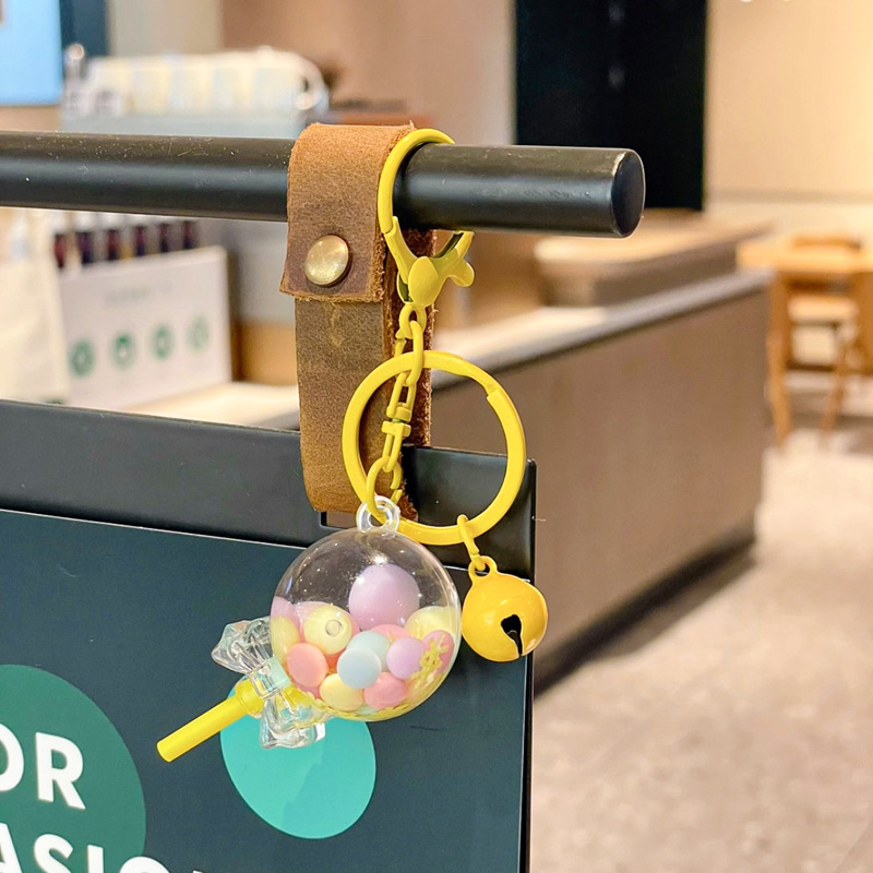 Caricatura en aceite líquido arena flotante botella mochila llavero delicado colgante accesorios accesorios máquina de muñecas pequeños regalos al por mayor