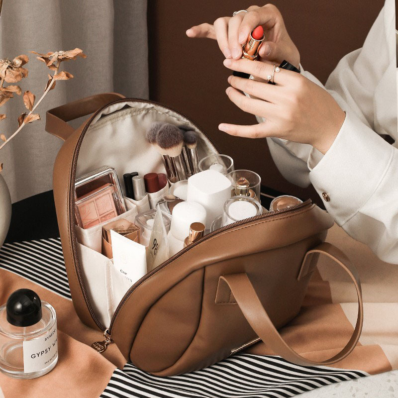 Capacious handheld cosmetic bag