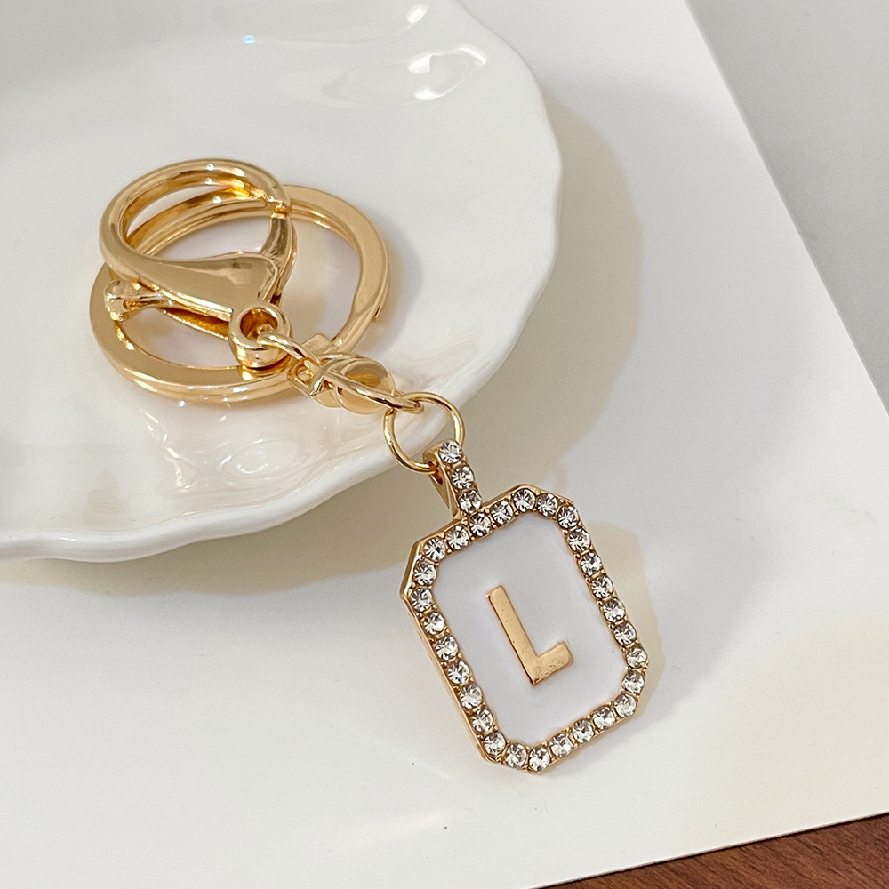 Nueva moda 26 cartas gota de diamante aceite llavero bolso del auricular pareja colgante vacaciones pequeño regalo al por mayor