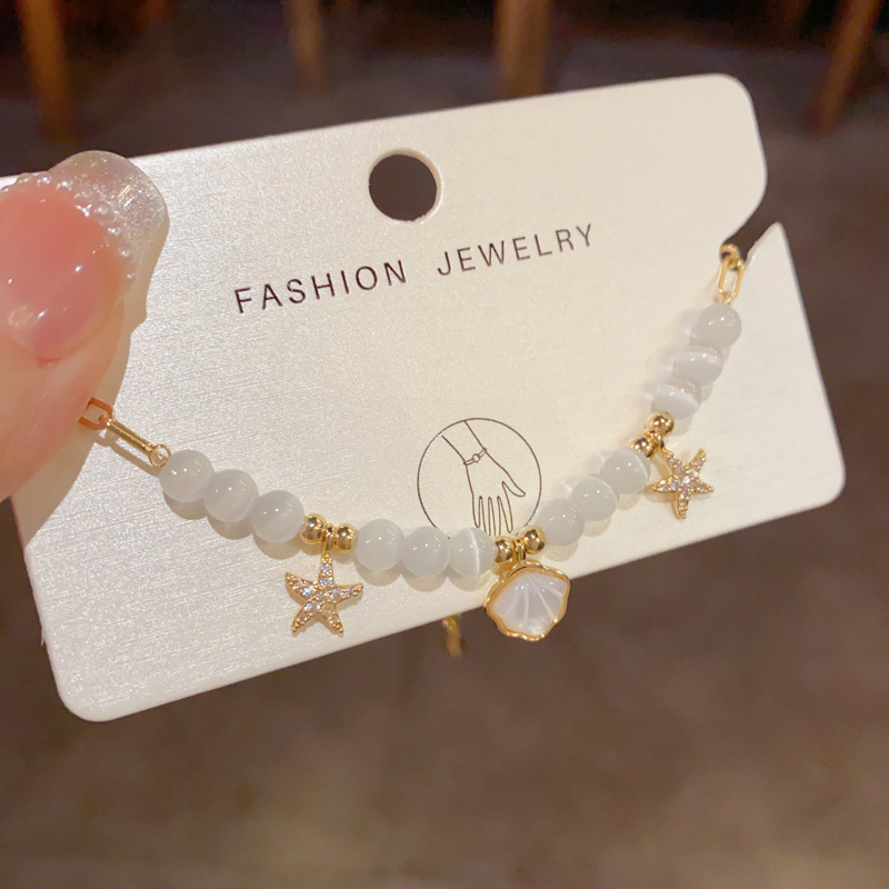 Pulseira elegante em pedra olho de gato com concha e estrela_voghion.com