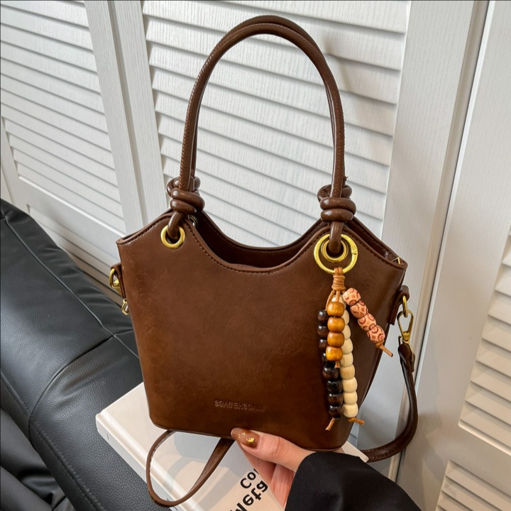 Coreano retro cuero suave bolso de cubo de mano 2025 nuevo estilo de alto nivel bolso de hombro de moda bolso de viaje para mujeres