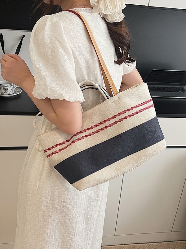Versión coreana del bolso Tote a rayas a juego de color de gran capacidad para mujer 2025 nuevo bolso de hombro de estilo perezoso de textura occidental simple