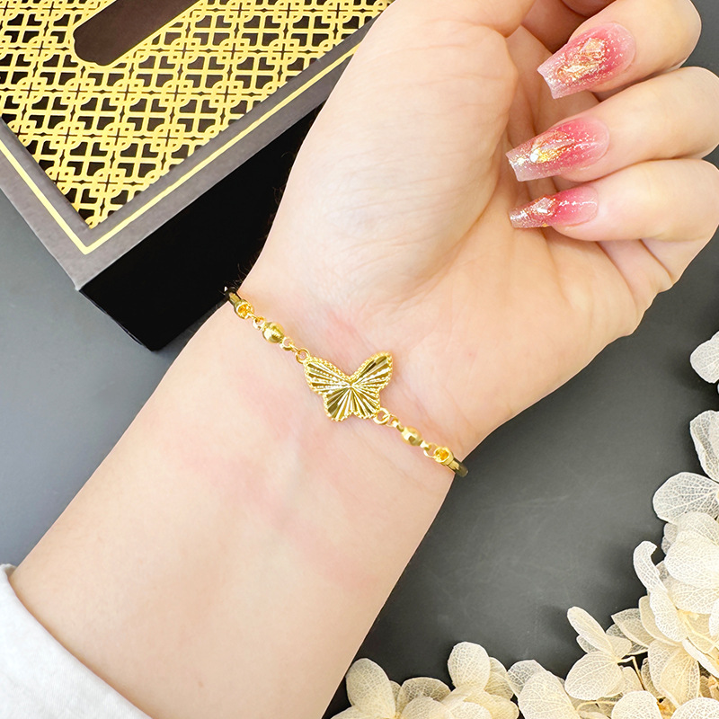 Simples y lujosos viento de oro de arena vietnamita mariposa pulsera de tubo de cobre de alta feminidad joyas de aleación de cobre en línea