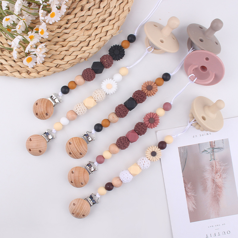 Productos para bebés Clip de chupete de haya Dibujos animados de bebé creativo pequeña margarita pequeña mordedor molar cadena de chupete anti-caída