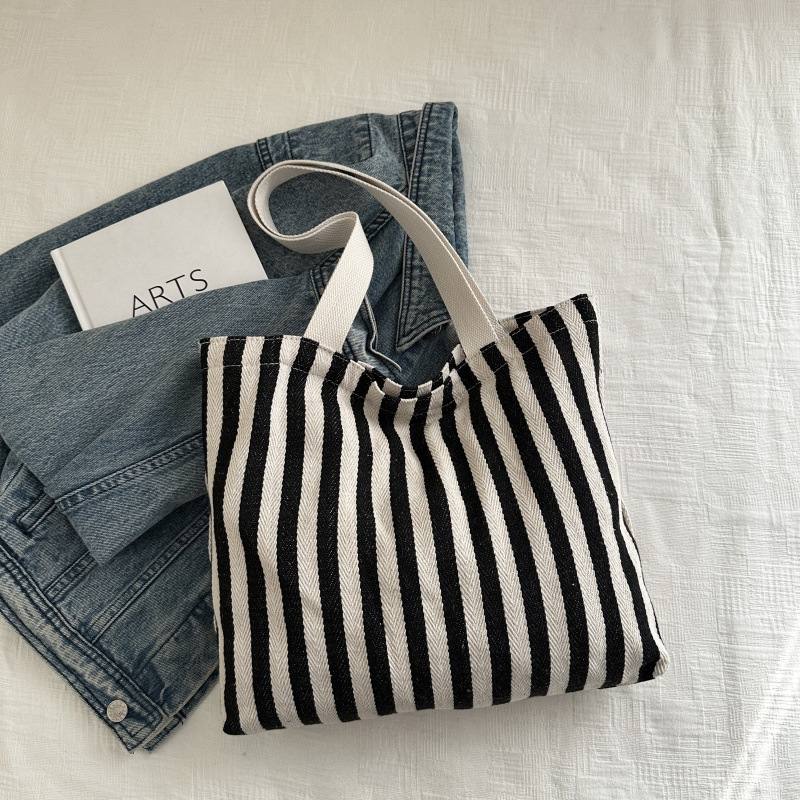 The new cross-border vertical striped commuter tote bag, hand-held shoulder bag, is fashionable and has a large capacity. It features an InS-style simple letter sail undefined