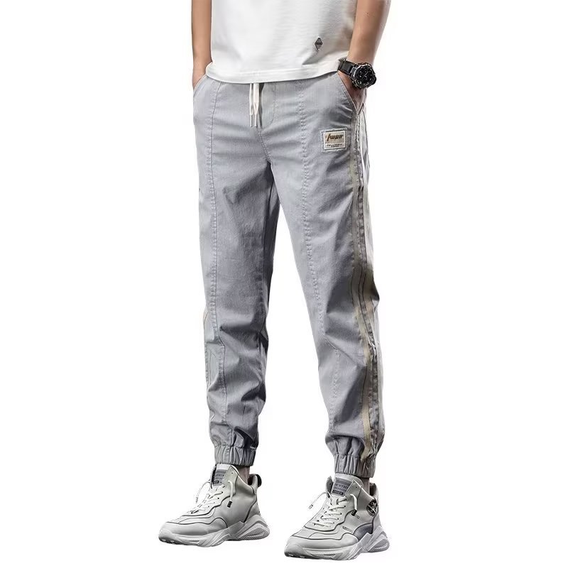 Pantalones de herramientas para hombres, modelos de primavera y otoño, moda de marca de moda, otoño delgado, pies sueltos, pantalones vaqueros de talla grande en forma de cono Harlan para hombres