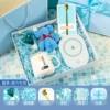 Blue ceramic spoon, towel, postcard with butterfly, flashing light