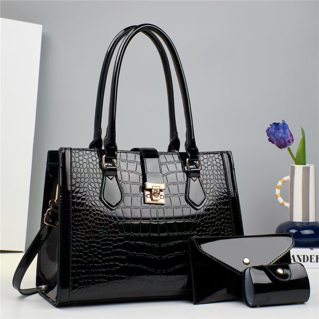 El nuevo conjunto de cuero brillante de tres piezas, con patrón de cocodrilo empalmado, tiene un bolso de mujer de gran capacidad, de un solo hombro y de paso cruzado, de calidad comercio extranjero