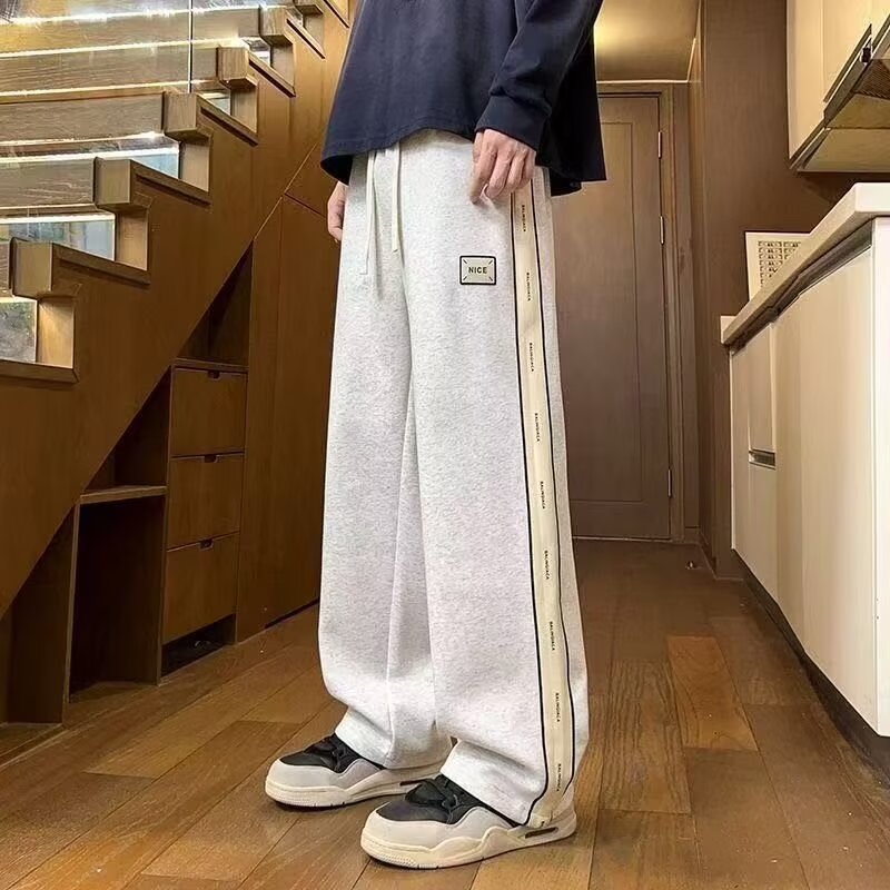 Pantalones casuales de hombre, tendencia de otoño y invierno, pantalones rectos de tamaño grande, pantalones deportivos elásticos de cintura delgada y caída.