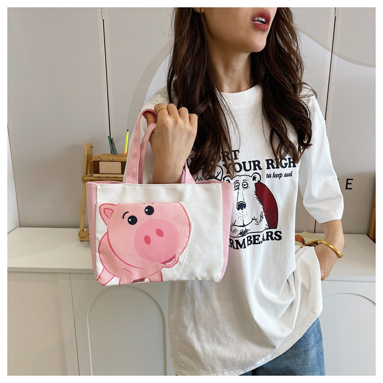 Cute cartoon printed small bag, 2024 summer new style hand-held piggy girl handbag, student storage canvas bag undefined