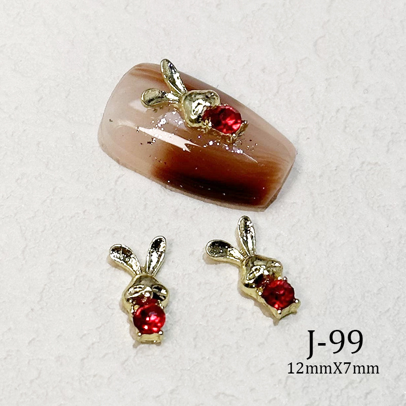 2023 Nueva joyería de uñas Año nuevo rojo aleación conejo rojo mariposa de cristal pintura en aerosol arco accesorios de diamantes de uñas