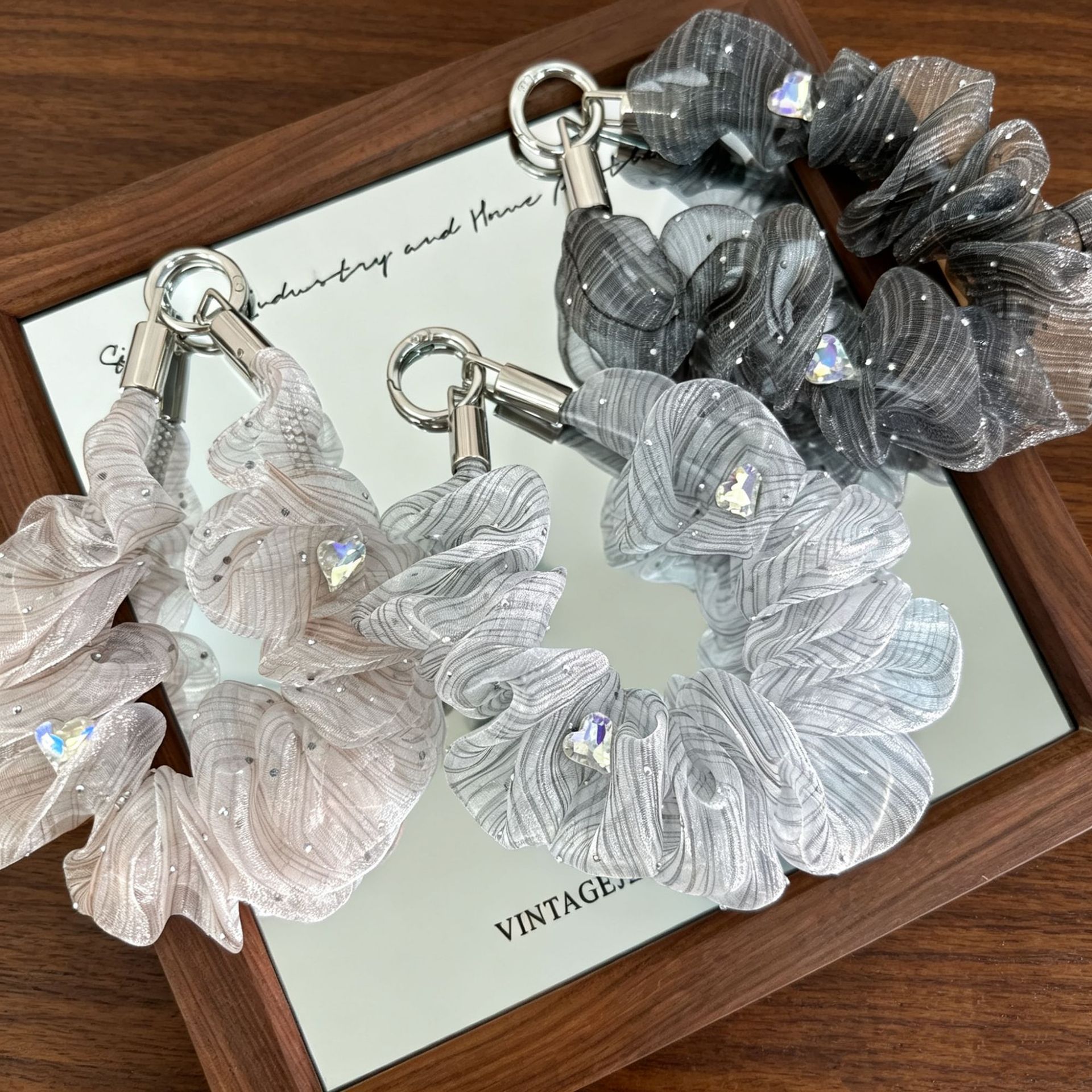Ethereal shimmering tulle heart-shaped rhinestone phone strap, a luxurious and lightweight mesh wrist cord, perfect as a bag or keychain accessory