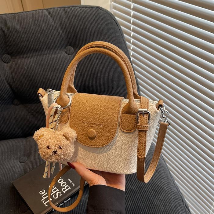 Bolsos pequeños de mano más vendidos de comercio exterior para mujer 2025 nuevo bolso cuadrado pequeño simple y todo fósforo textura casual bolso de mensajero de un solo hombro