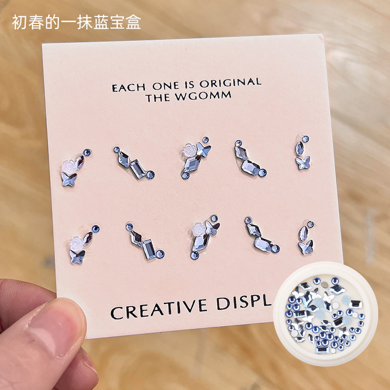 Desgaste de la celebridad en línea paquete de material de uñas caja del Tesoro japonés accesorios de uñas corazón torcido Mariposa Super Flash accesorios de uñas de diamante en forma especial