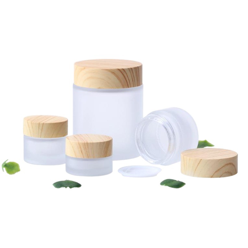 Venta al por mayor cubierta de grano de madera 50g botella de crema para los ojos botella de crema facial crema de vidrio esmerilado sub-botella de transferencia de agua muestra de impresión
