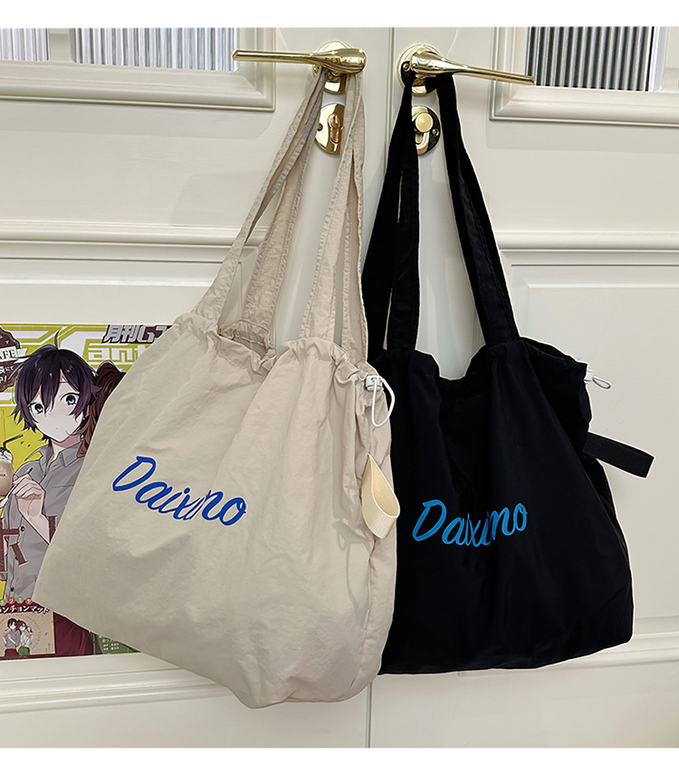 Solid color large-capacity tote bag 2025 bestseller, fashionable commuting lightweight handbag, laid-back style drawstring nylon bag for women undefined