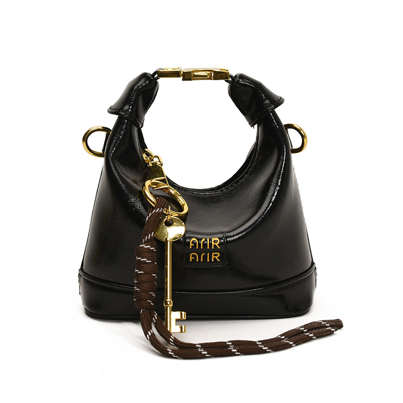 Bolso de hombro para niña coreana bolso de bebé con bloqueo de cuero de aceite de color sólido simple 2025 nuevo mini bolso para niños