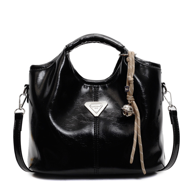 Popular bolso de mano super caliente para mujeres 2025 nueva moda versátil bolso de hombro para viajar bolso de cubo de textura superior
