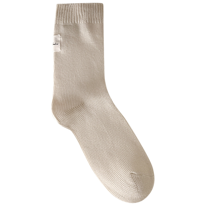 Otoño e invierno Nuevos calcetines de algodón absorbentes de sudor calcetines de pila serie de crema para mujer estilo ins Corea del Sur etiqueta de tela calcetines de media pantorrilla moda