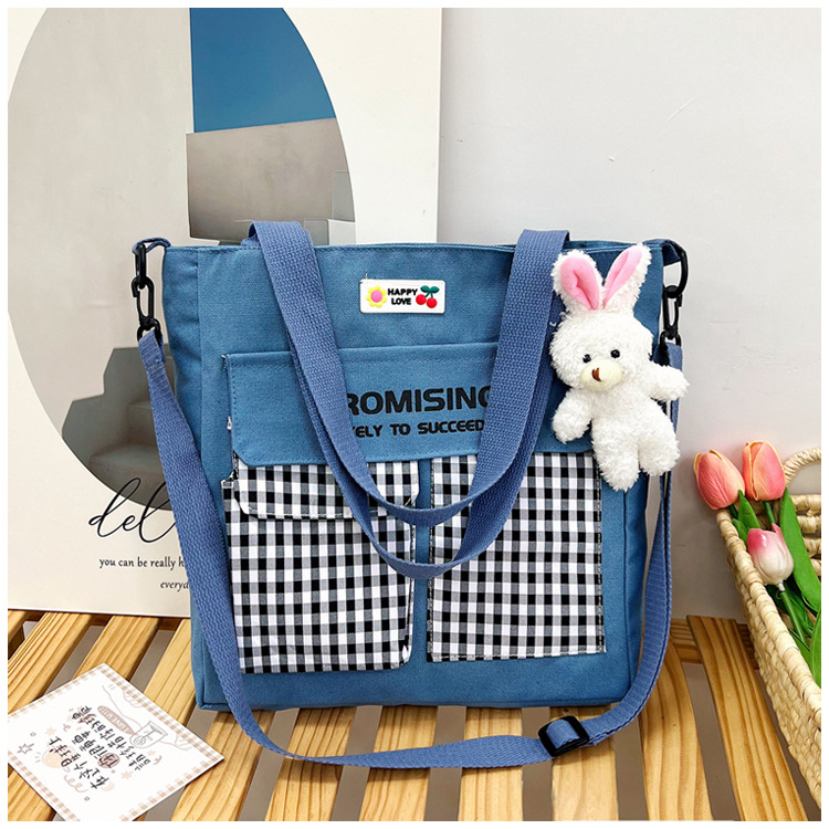 The new Korean-style cute nylon bag for class tutoring is a versatile checkered single-shoulder bag that is selling well (with a bear) undefined