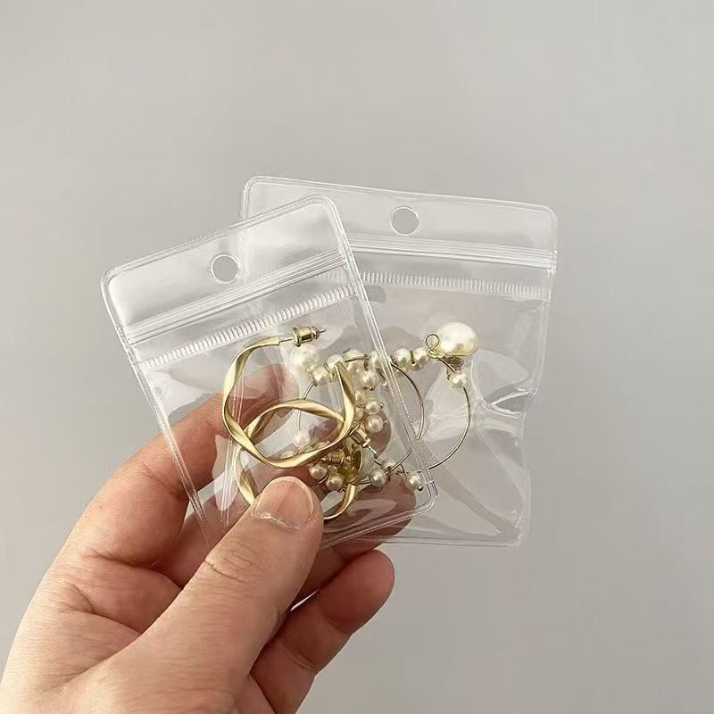 Perforated PVC transparent self-sealing bag, hangable protective cover, storage and packaging bag for bracelets and jewelry, custom plastic bags Perforated PVC transparent self-sealing bag, hangable protective cover, storage and packaging bag for bracelets and jewelry, custom plastic bags