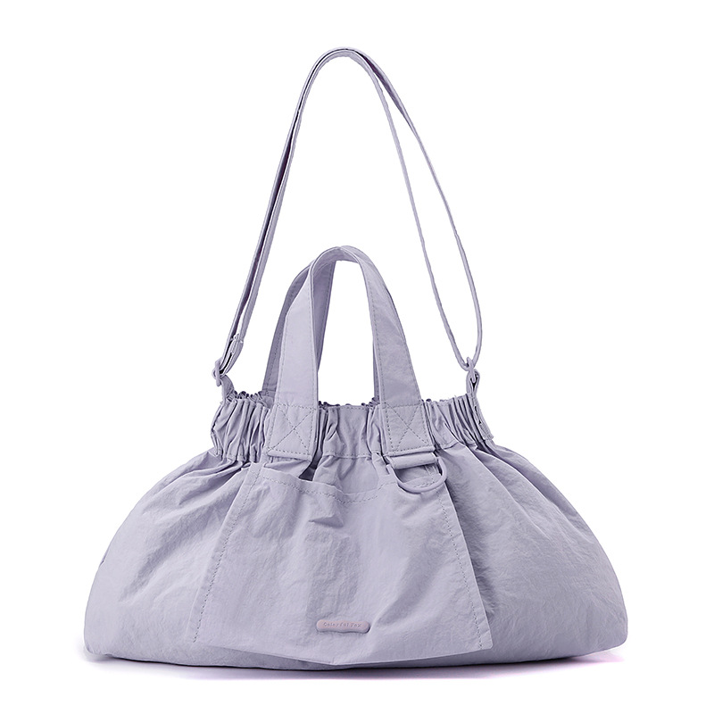 El nuevo diseño de nicho coreano del comercio exterior tiene un sentido del conocimiento de embarque a mano y una bolsa de mujer en el hombro es ligera, casual y plegable.