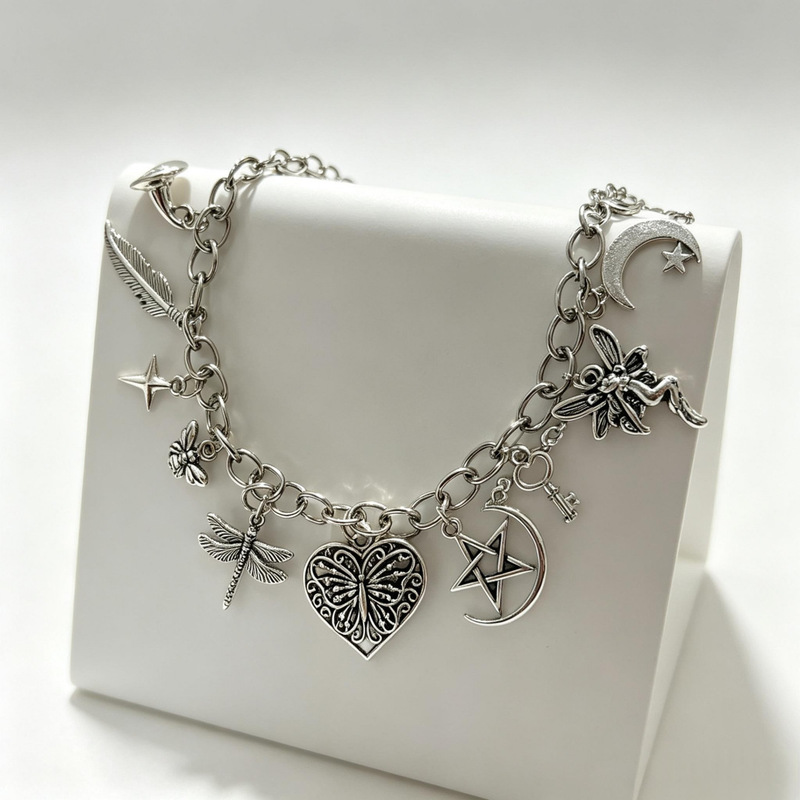 Trendy multi-pendant bracelet for women with feather, butterfly, flower, star, moon, heart, four-pointed star, and dragonfly designs, featuring a unique niche aesthetic