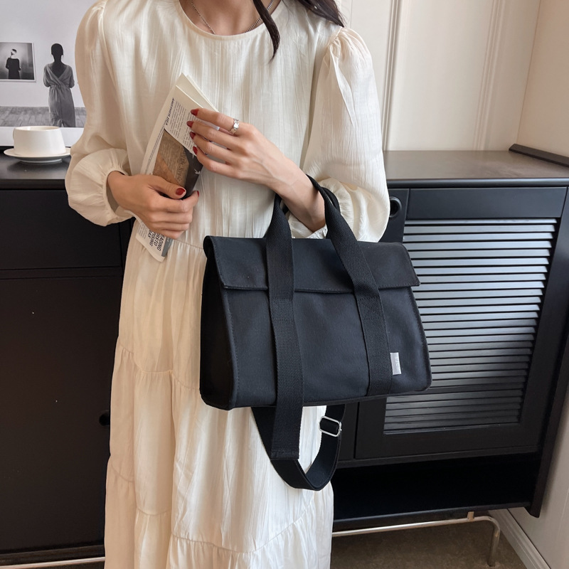 Comercio exterior bolsa de lona para las mujeres 2023 nueva moda japonesa y coreana bolsa de mano portátil nicho de alta calidad bolsa de mensajero del hombro