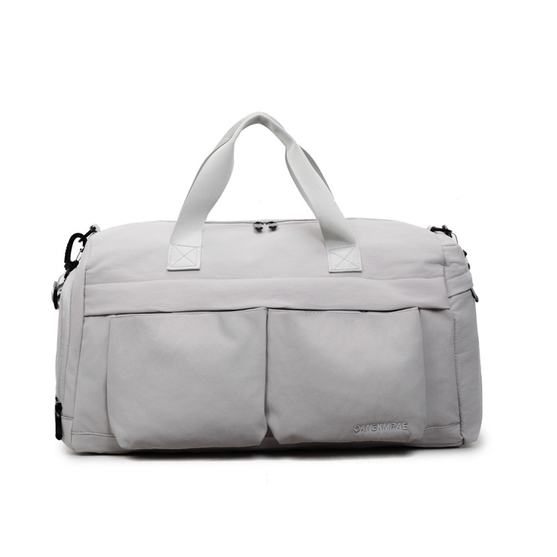 Nueva bolsa de viaje portátil simple y versátil, bolsa de equipaje de gran capacidad para mujeres, bolsa deportiva leve y casual de alta calidad.