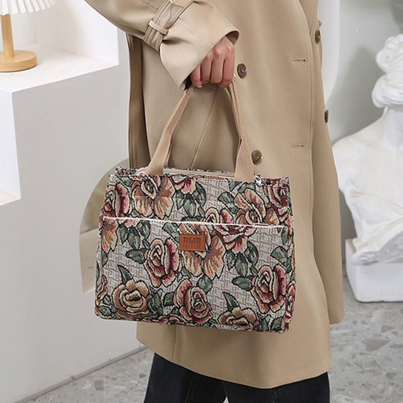 This retro handbag features a tote flower oil painting style. It's convenient to carry a lunch box to work. It has a large capacity and is a mommy bag for going out undefined
