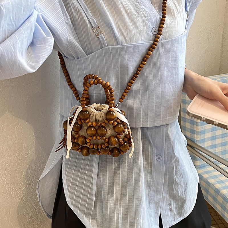 Nuevo bolso chino para niños con cuentas extranjeras, mini mochila para niños, bolsa de hombro de bebé tejida hueca