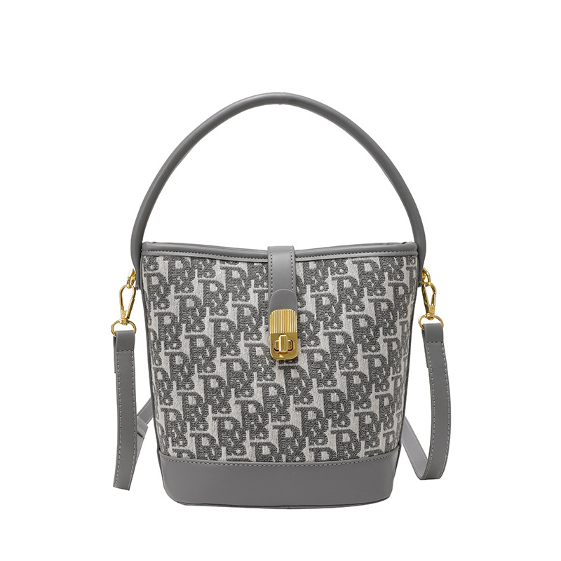 Bolso de mano exquisito de alta gama para mujer 2025 nuevo bolso de cubo retro con estampado de tela bolsa de mensajero de un solo hombro de nicho