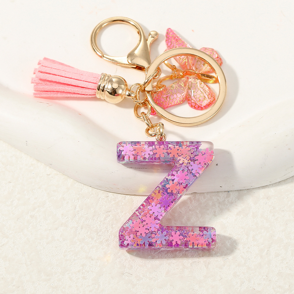 Nuevo color púrpura claro mezcla de polvo brillante letras inglesas resina llave colgante estilo simple mariposa borda colgante