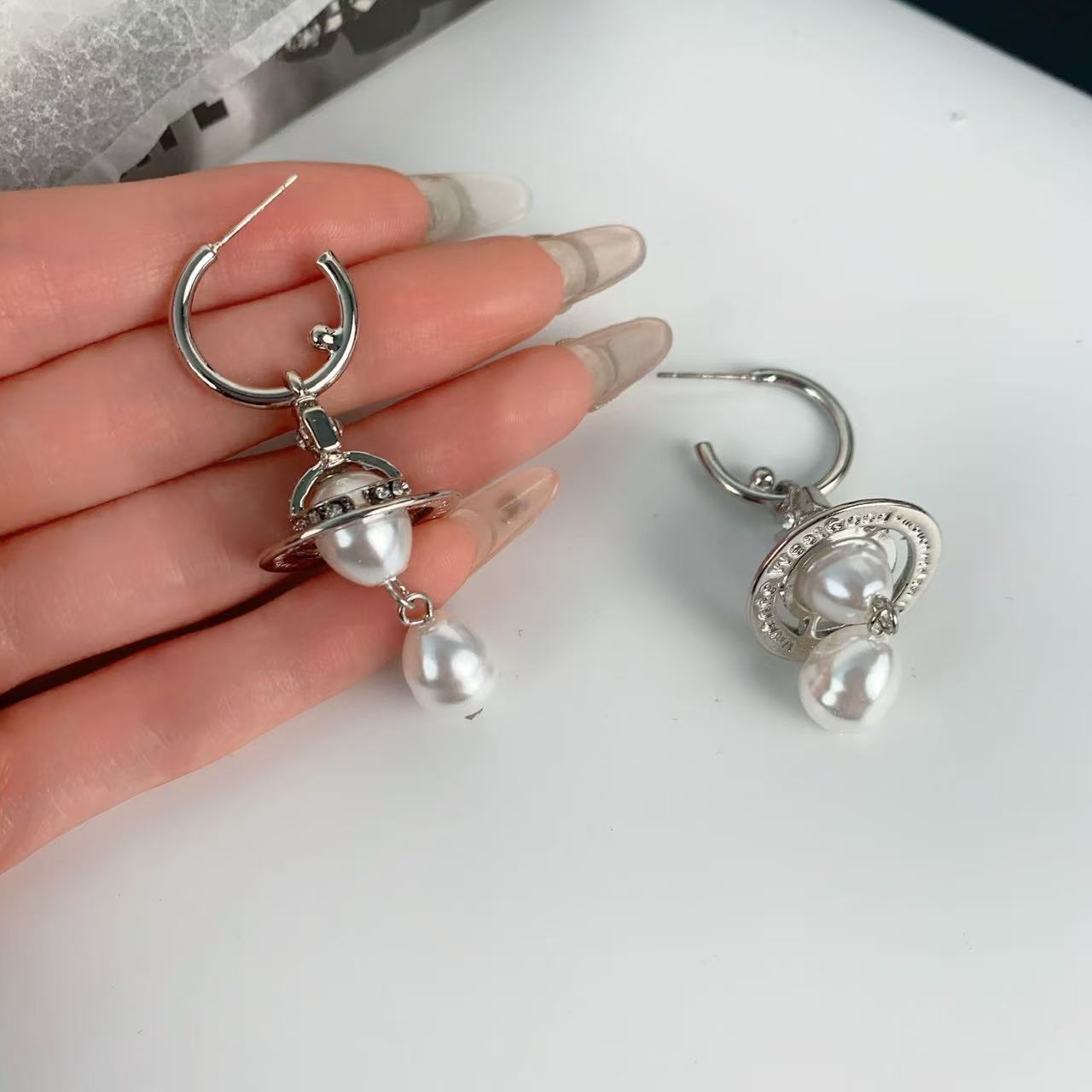 Classic three dimensional earrings drop-shaped from pearl with…